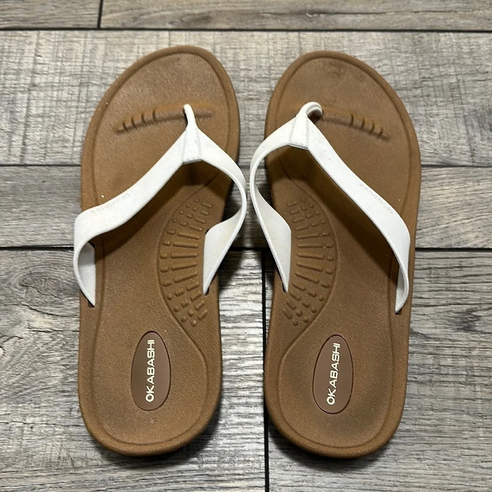 Okabashi flip flops with white straps and neutral color bottoms